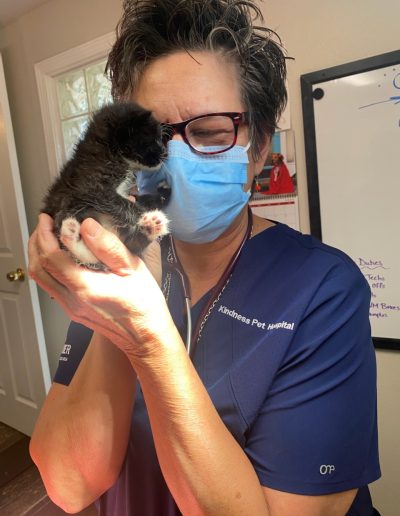 Mary hold black kitten at the office - Kindness Pet Hospital in Santa Rosa Beach Florida